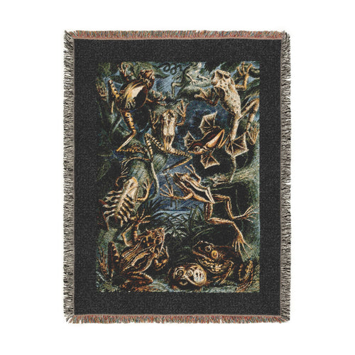 A rectangular woven blanket with fringed edges featuring Batrachia (Frogs) by Ernst Haeckel from Kunstformen der Natur (Art Forms in Nature) depicting long-limbed tree frogs, heavily patterned species, compact terrestrial forms, and other amphibians throughout a dense natural setting within a dark border.  Shown against a solid white background.