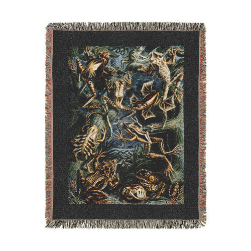 A rectangular woven blanket with fringed edges featuring Batrachia (Frogs) by Ernst Haeckel from Kunstformen der Natur (Art Forms in Nature) depicting long-limbed tree frogs, heavily patterned species, compact terrestrial forms, and other amphibians throughout a dense natural setting within a dark border.  Shown against a solid white background.