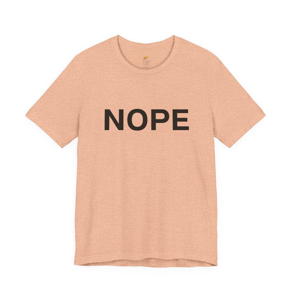A heather peach short-sleeve crewneck t-shirt with the word 'NOPE' printed in bold black capital letters across the chest, displayed on a clean white background.