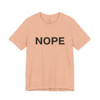 A heather peach short-sleeve crewneck t-shirt with the word 'NOPE' printed in bold black capital letters across the chest, displayed on a clean white background.