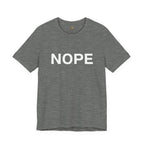 A deep heather gray short-sleeve crewneck t-shirt with the word 'NOPE' printed in bold white capital letters across the chest, displayed on a clean white background.