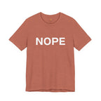 A heather clay short-sleeve crewneck t-shirt with the word 'NOPE' printed in bold white capital letters across the chest, displayed on a clean white background.