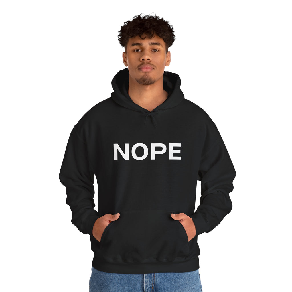 A man wearing a black pullover hoodie with a white bold graphic 'NOPE' design standing against a white background