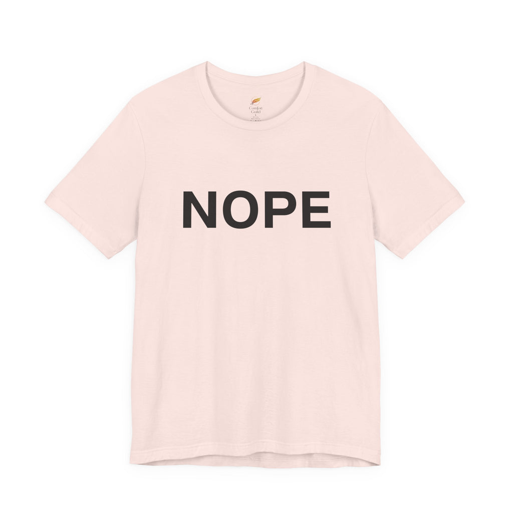 A soft pink short-sleeve crewneck t-shirt with the word 'NOPE' printed in bold black capital letters across the chest, displayed on a clean white background.