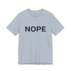 A light blue short-sleeve crewneck t-shirt with the word 'NOPE' printed in bold black capital letters across the chest, displayed on a clean white background.