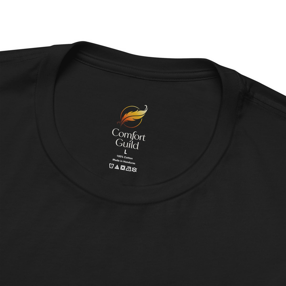 Close-up of a black Comfort Guild t-shirt neck label, showing the brand logo and care instructions printed inside the collar.