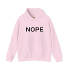 A soft pink pullover hoodie with the word 'NOPE' printed in bold black capital letters across the chest on a solid white background.